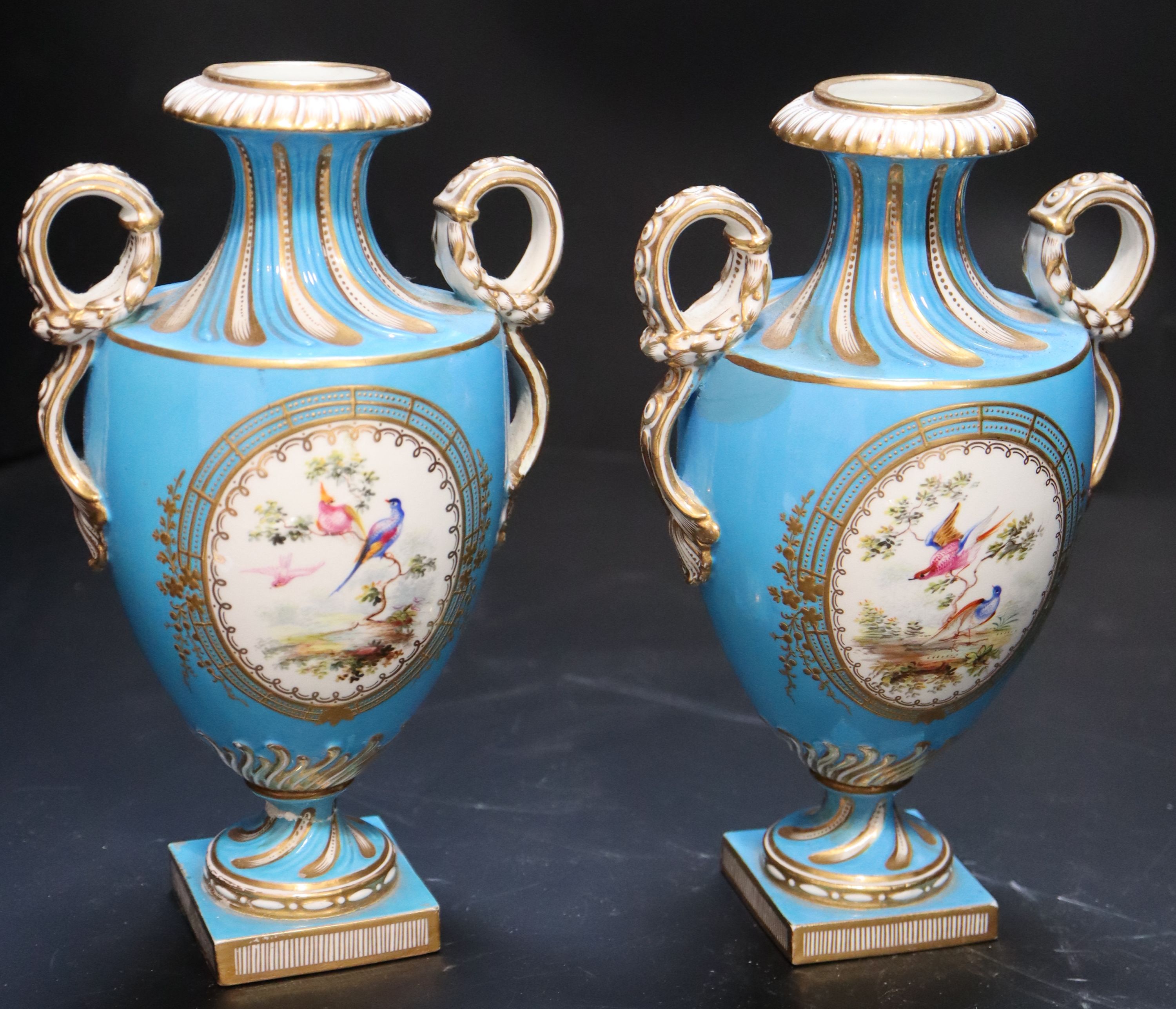 A pair of mid 19th century Coalport turquoise ground two handled vases, height 21cm.